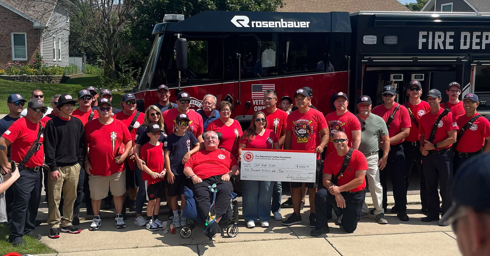 Chief Hugh Stott and family receiving a donation check.