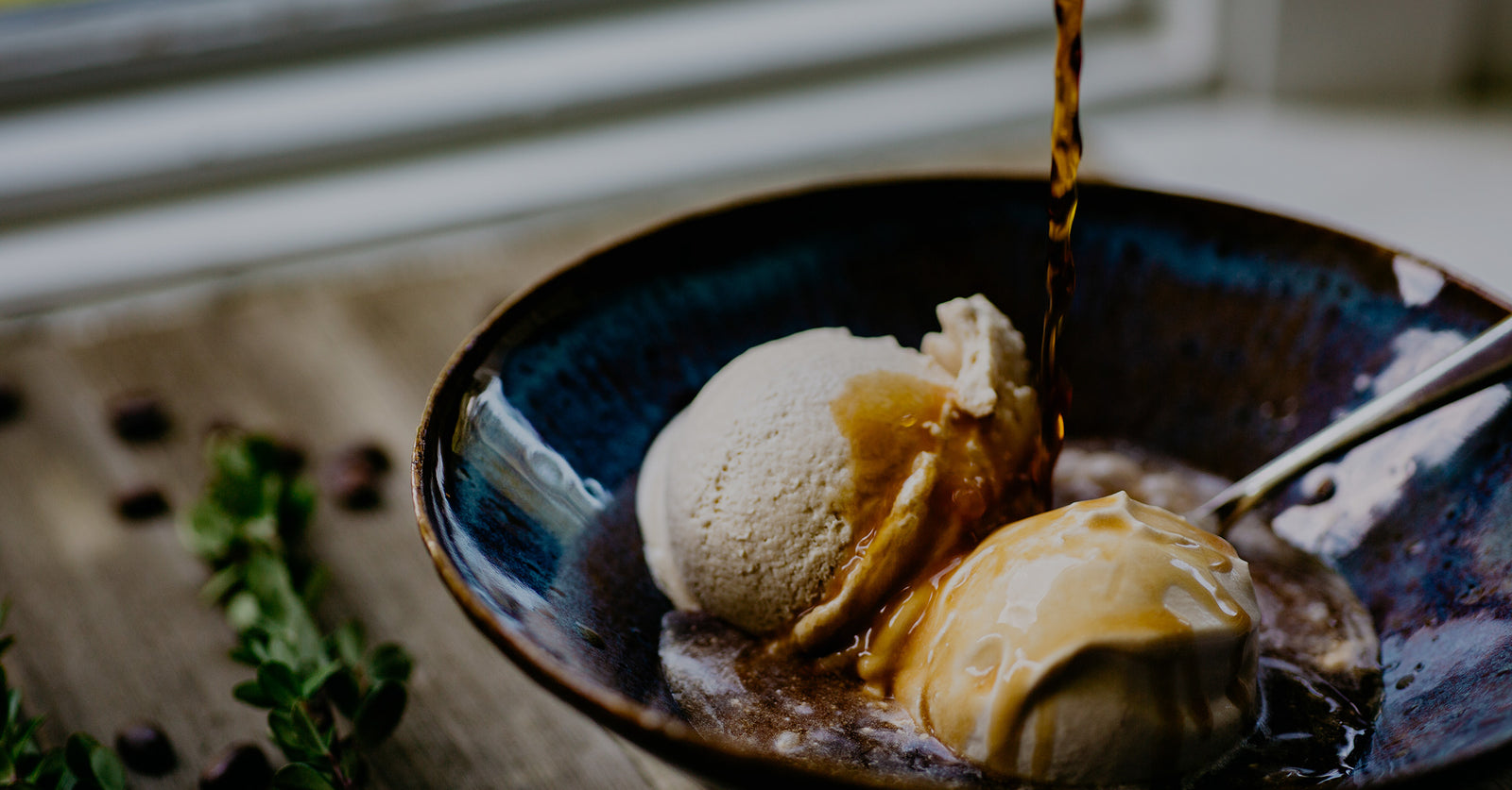 Ice cream in a bowl with cold brew coffee pouring on top.