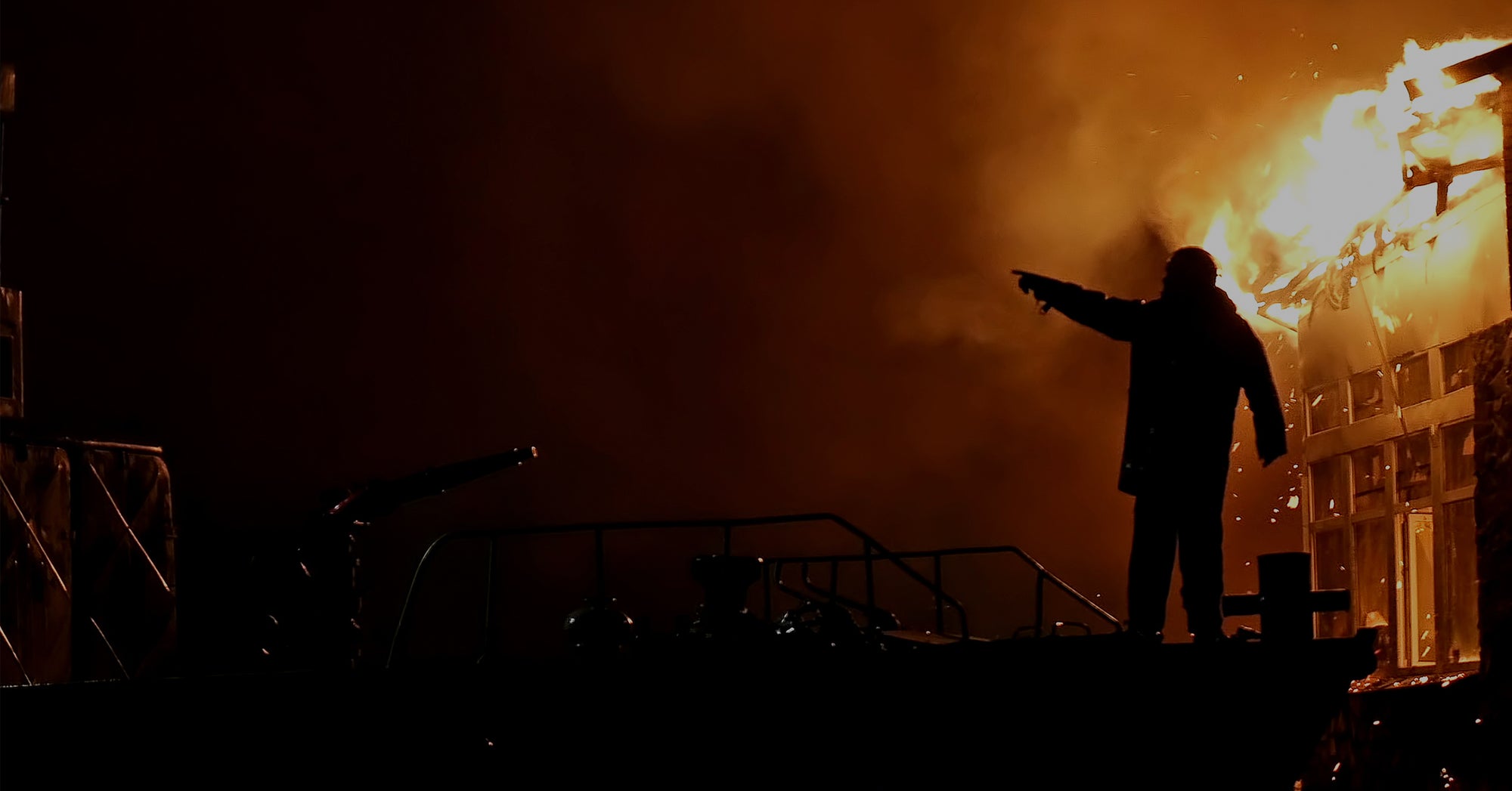 Firefighter pointing amidst flames
