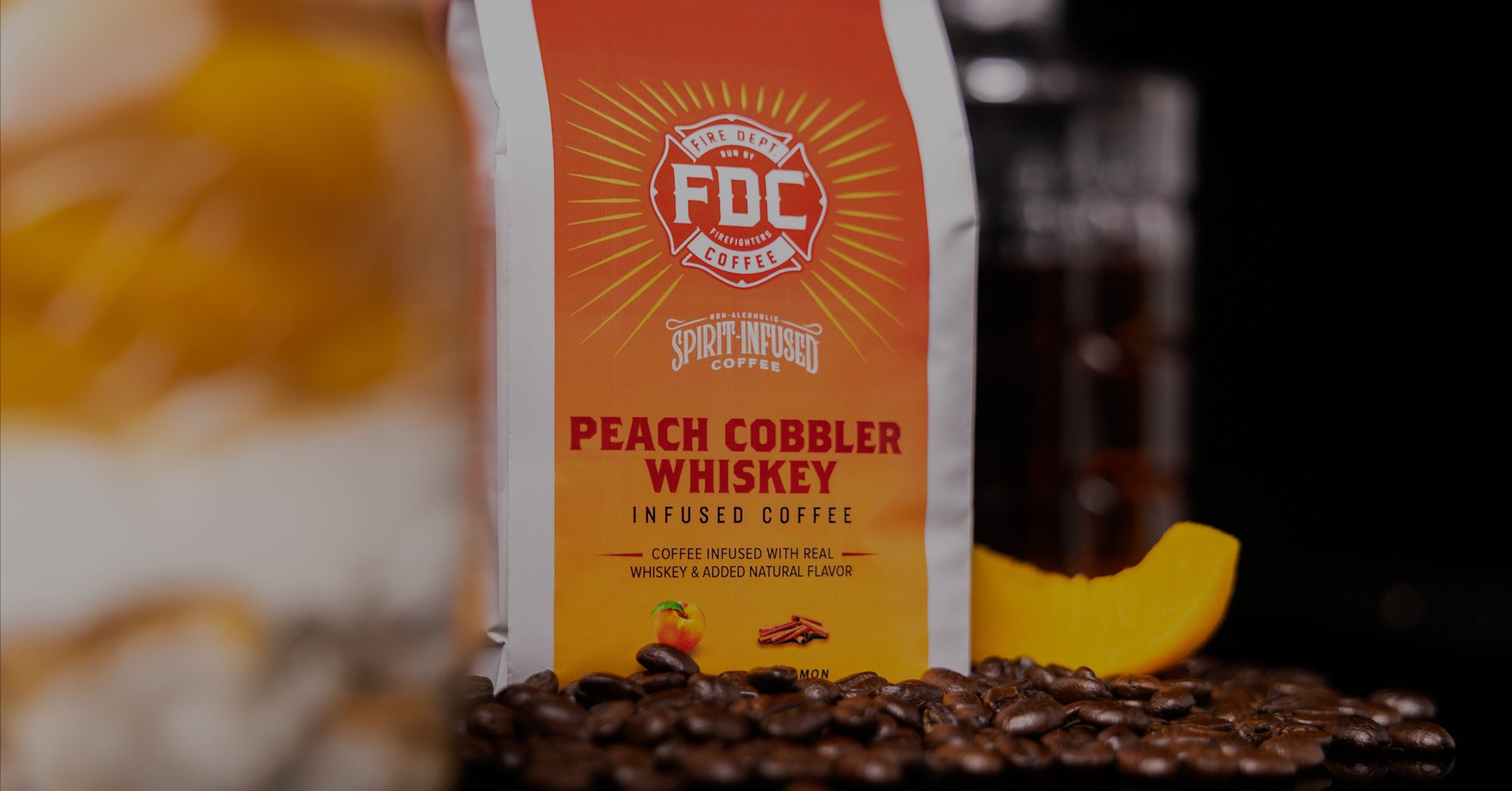 Bag of Peach Cobbler Whiskey coffee and coffee beans scattered.