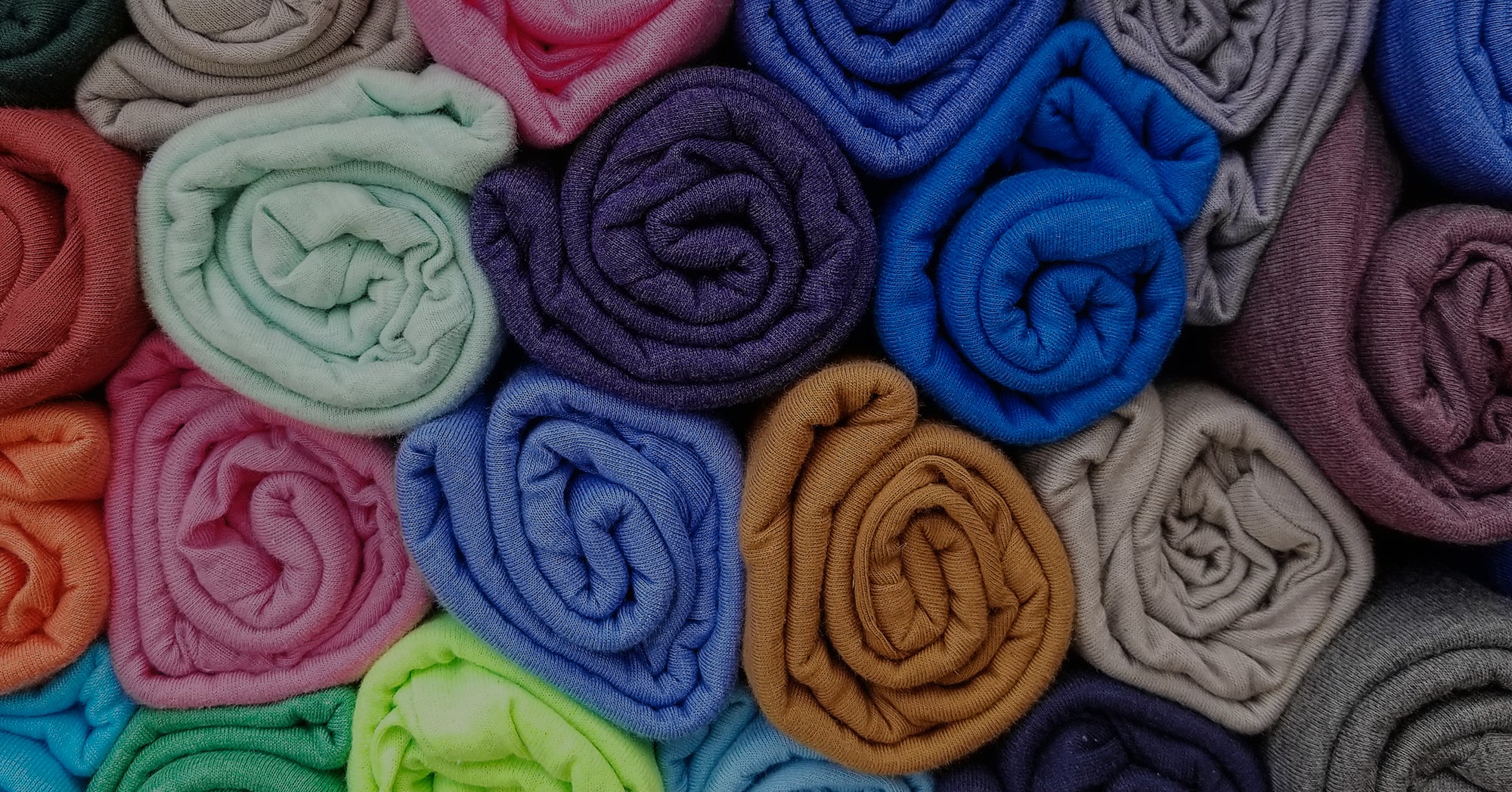 Rolled up t-shirts in various colors.