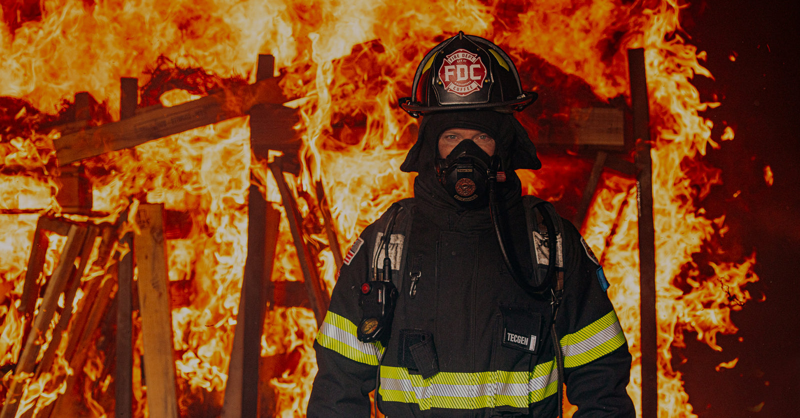 Firefighter standing in a burning structure.