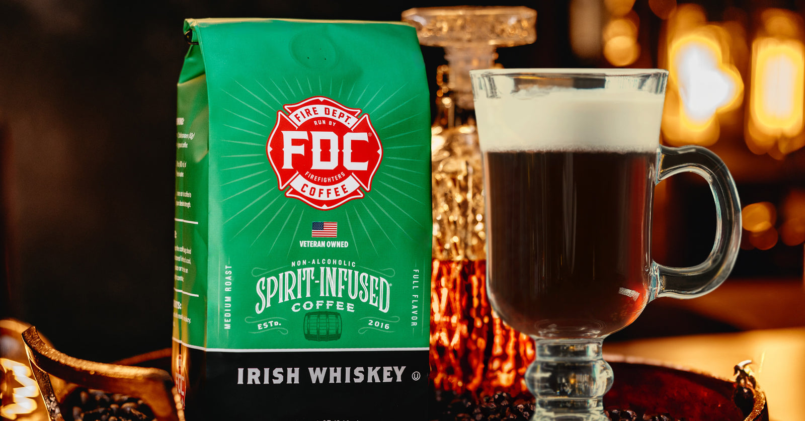 Image of an Irish Coffee with foam in front of an Irish Whiskey Infused Coffee bag.