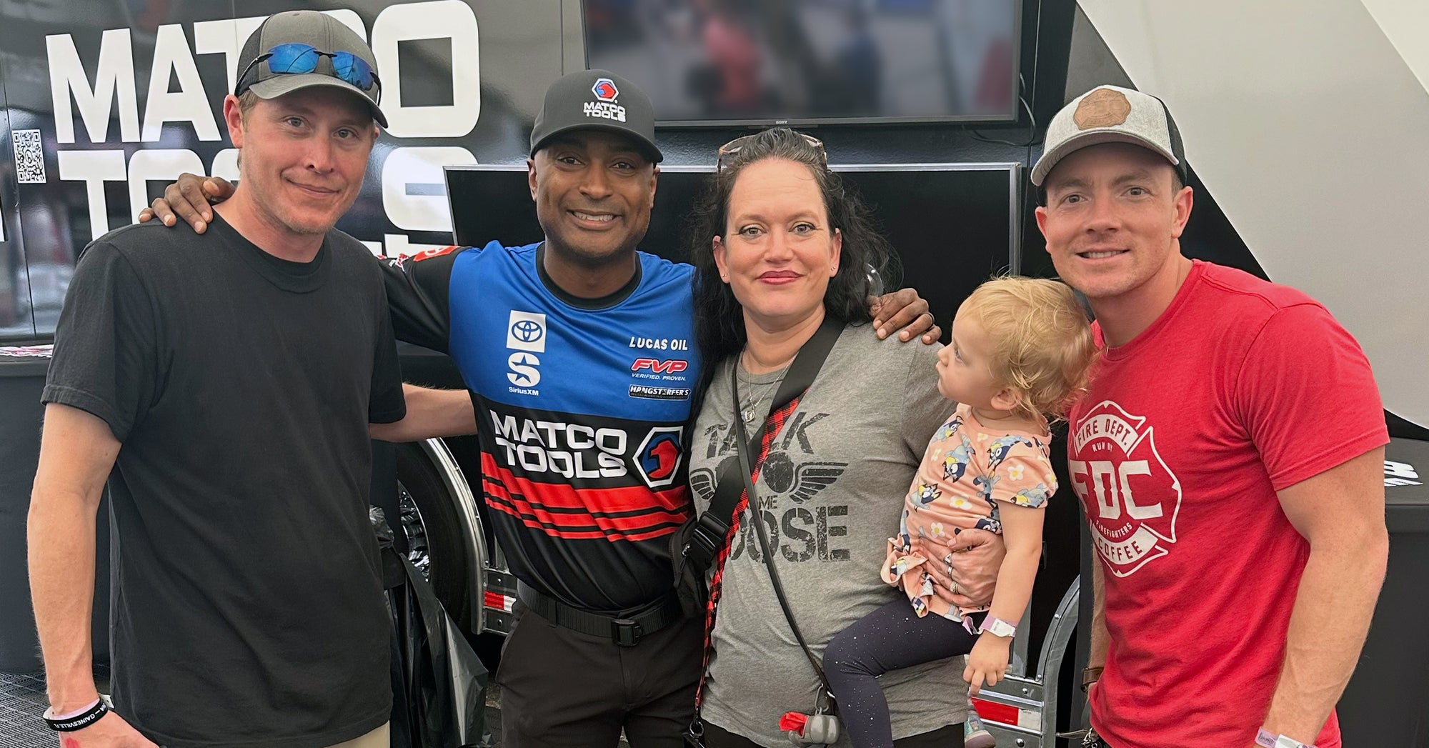 NHRA Community Hero, Kristy Manley with Top Fuel Champion, Antron Brown.