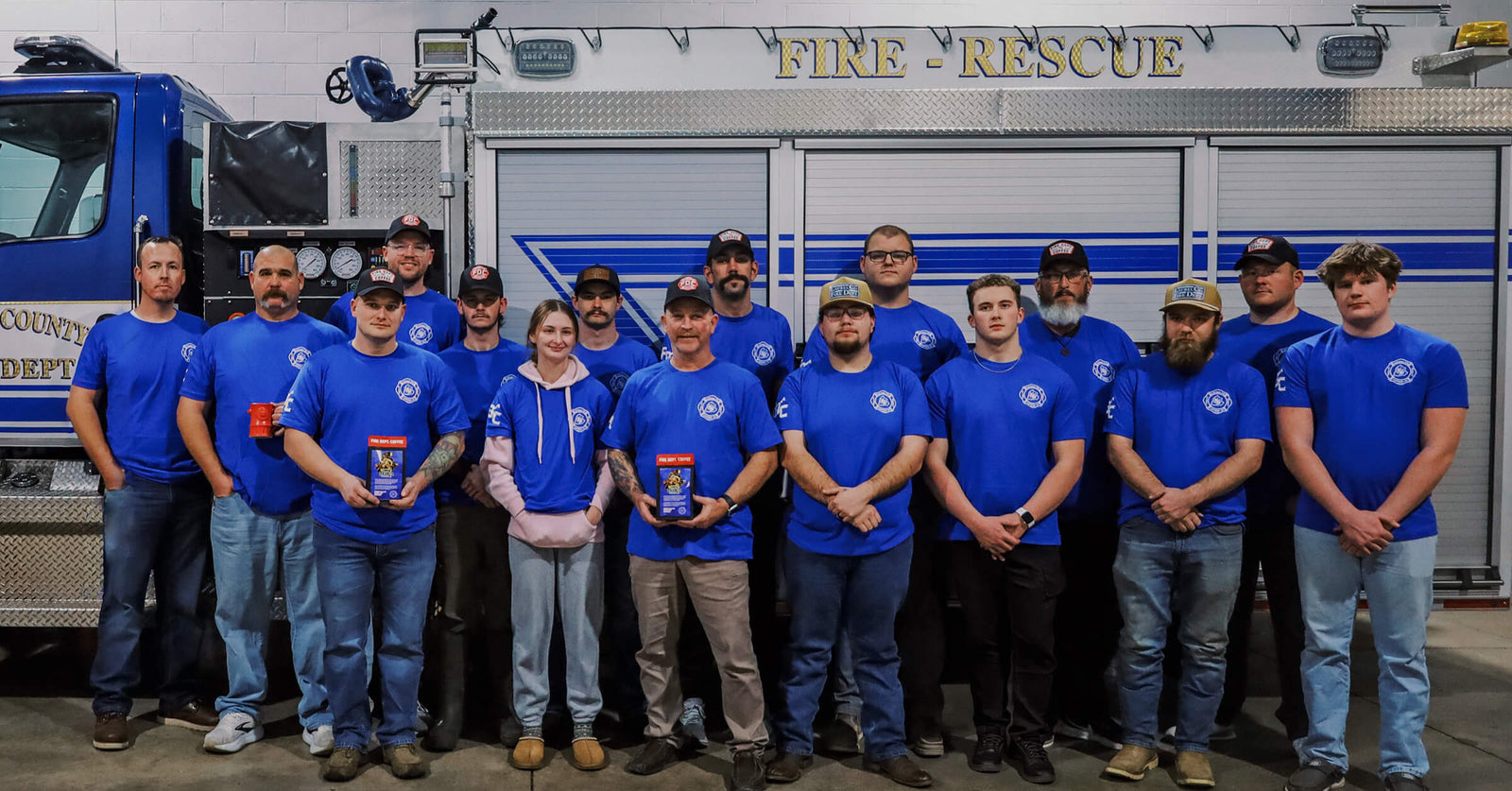 Firefighters of Laurel County Fire Department in Kentucky standing together next to a fire truck.