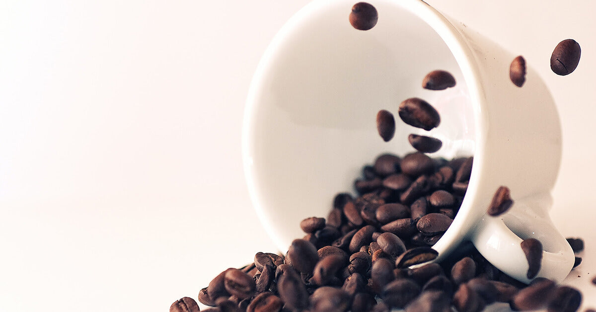 Cup of spilled coffee beans