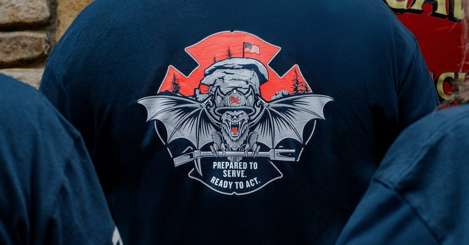 Closeup of the Fire Dept. Club shirt featuring a bat and Chimney Rock national park in the background.