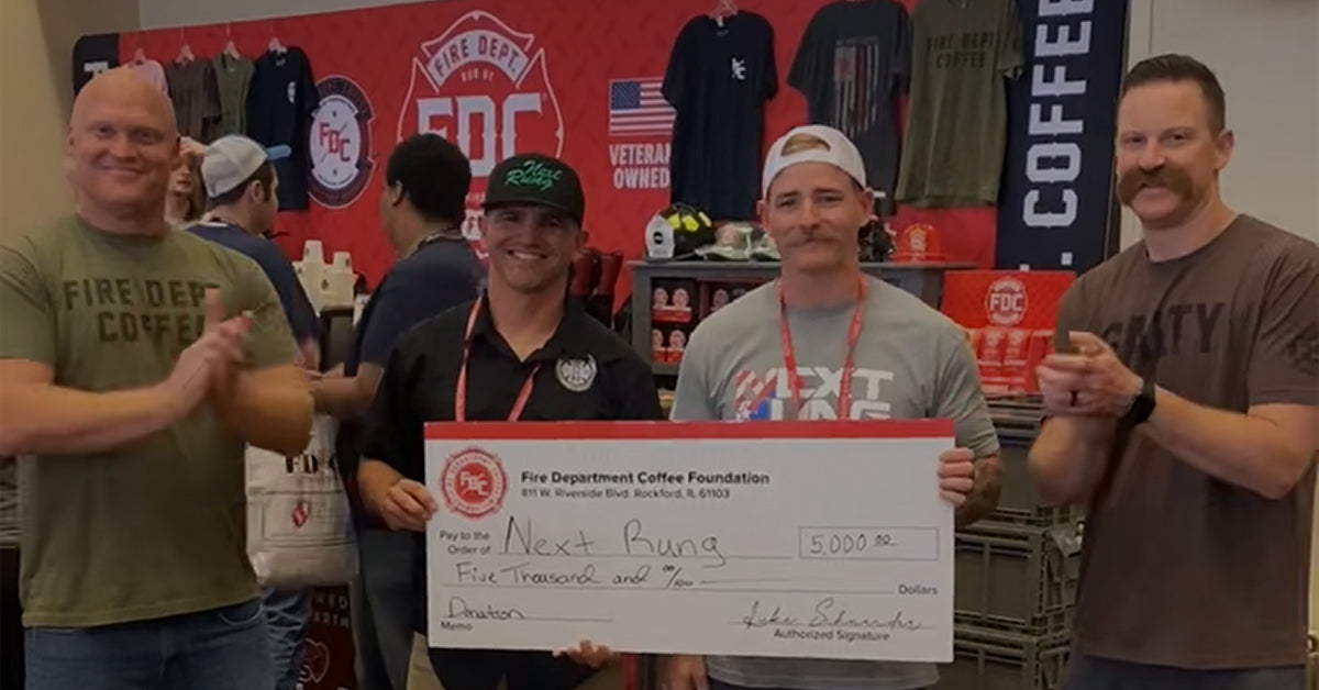 Next Rung, Firefighter Mental Health organization members holding an oversized donation check.