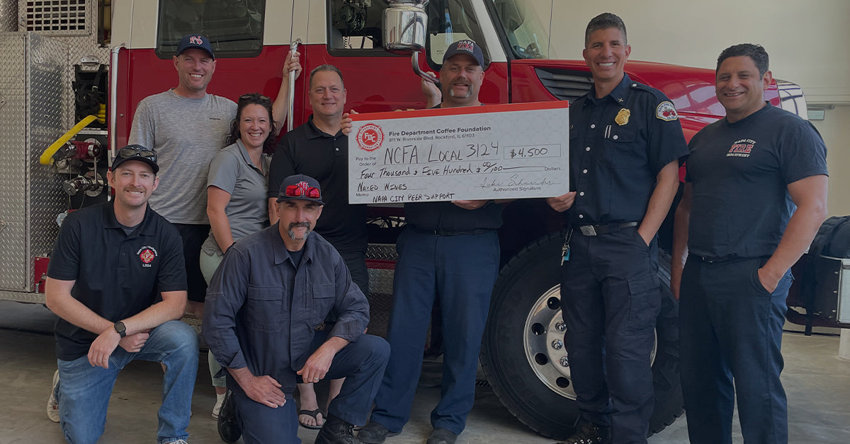 Image of firefighters of Napa Valley Fire Department holding a donation check from Fire Department Coffee Foundation.