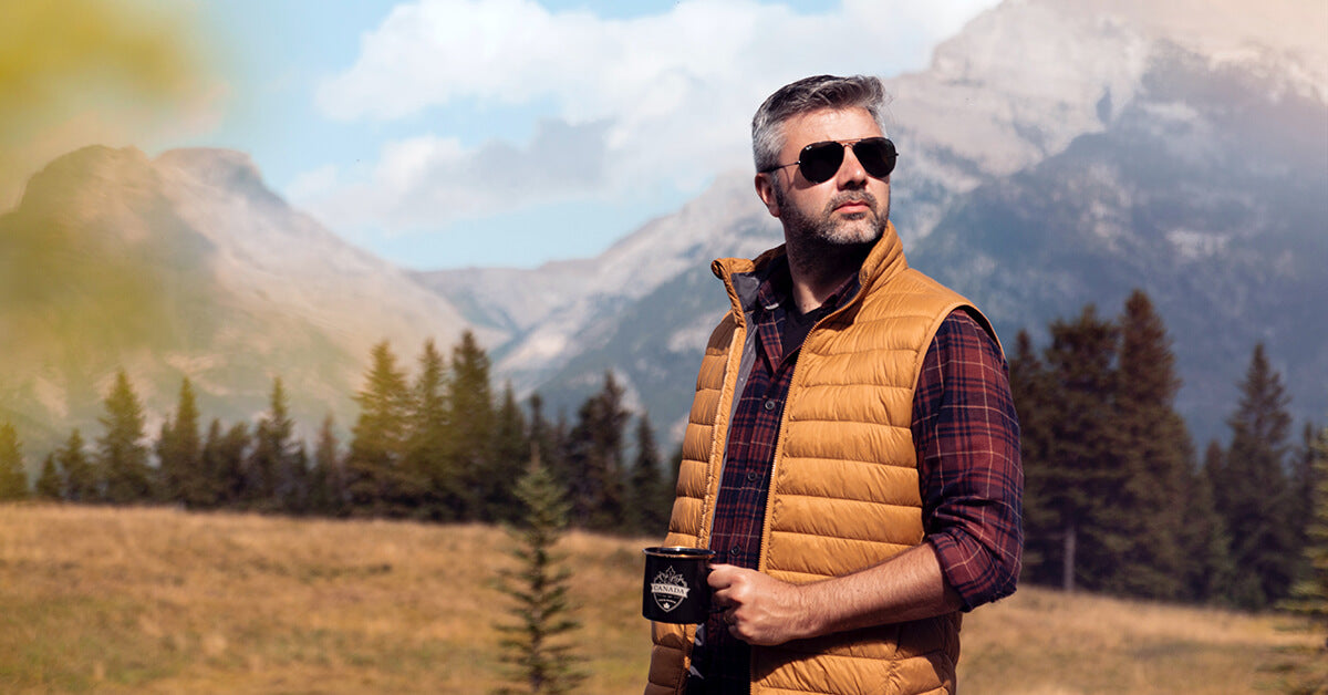 Man holding a coffee after brewing it with one of the best travel coffee makers