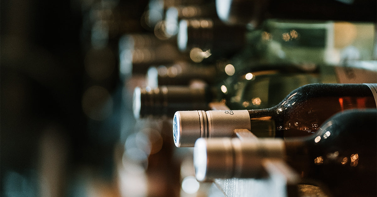 NakedWines.com, wine bottles on a shelf.