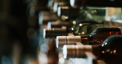 NakedWines.com, wine bottles on a shelf.