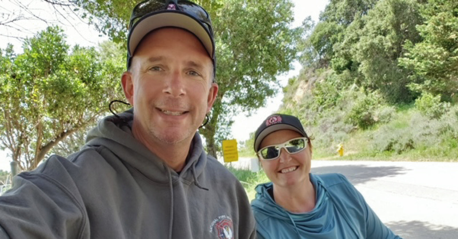 Ken Larsen and his wife smiling and riding bikes in California.