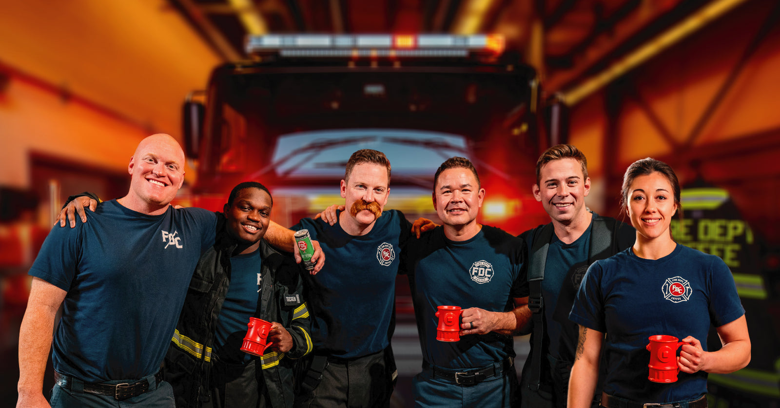 Group of firefighters gathered and smiling with coffee in hand.