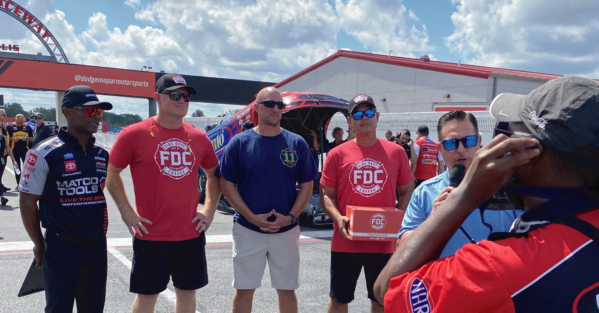 Community hero at the NHRA race in Indianapolis receiving award alongside the FDC team.