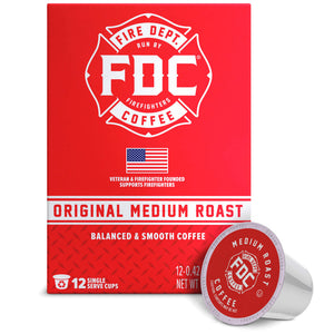 A red box of FDC Fire Department Coffee Single Serve K-Cups with one single-serve coffee capsule placed in front on a white background.