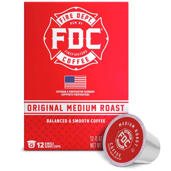 A red box of FDC Fire Department Coffee Single Serve K-Cups with one single-serve coffee capsule placed in front on a white background.