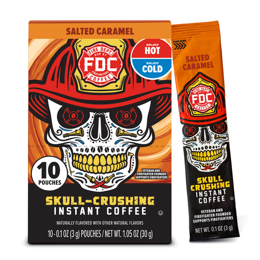FCD Fire Department Salted Caramel Instant Coffee packaging, showing a 10-count box alongside a single stick pouch. The design features a skull wearing a firefighter helmet with a red, orange, and black color scheme and a blue ’Enjoy Hot or Cold’ badge.