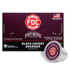 A box of FDC Fire Department Spirit Infused Coffee in Black Cherry Bourbon flavor, shown alongside two individual single-serve coffee capsules on a clean white background.