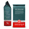 Two views of a Fire Dept Coffee bag of Decaf Medium Roast coffee, showing the front and back packaging on a white background.