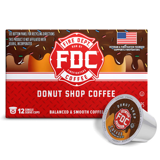 A box of FDC Fire Department Coffee ’Donut Shop Coffee’ alongside two individual single-serve coffee capsules on a clean white background.