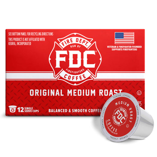 A red box of FDC Fire Department Coffee Original Medium Roast coffee capsules, shown with one silver and red single-serve coffee capsule in front on a white background.