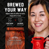 Promotional coffee advertisement with a smiling woman holding a red mug on the right, and product information on the left. The left side includes the text 'BREWED YOUR WAY,' serving suggestions, and a bag of Spirit Infused Coffee labeled Pumpkin Pie Bourbon.