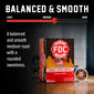A box of FDC Fire Department Coffee Donut Shop Coffee in the Balanced & Smooth medium roast variety, shown alongside a single coffee capsule on a dark background with marketing text and a roast slider graphic.