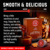 Promotional graphic for FDC Spirit Infused Coffee Caramel Bourbon, showing the product box, a capsule, caramel sauce, and coffee beans on a dark background with a flavor slider labeled 'Smooth & Delicious'.