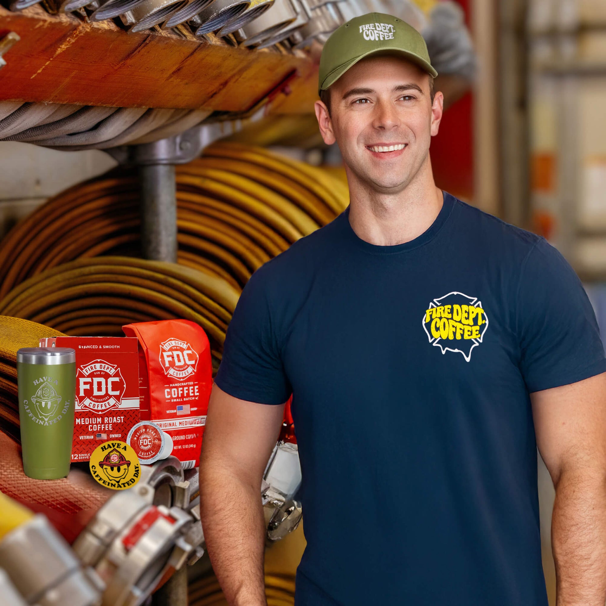 A collection of products in the Groovy Bundle including the Navy Blue Have a Caffeinated Day shirt, Green dad hat, Medium Roast Coffee, a green coffee tumbler, and a yellow Have a Caffeinated Day sticker.