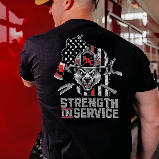 black t-shirt with a graphic design and text ’Strength in Service’ on the back.