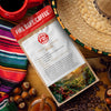 Fire Dept. Coffee package with coffee beans, a cup, and a hat on a wooden surface

