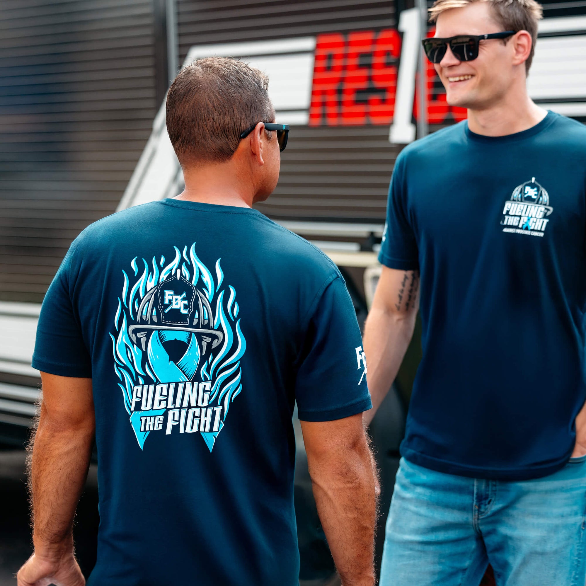 Navy blue t-shirt with a graphic design on the back, supporting firefighters battling prostate cancer.