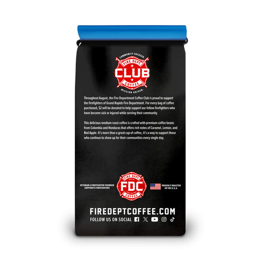 A black bag of Fire Department Coffee by Fire Dept Coffee Co. with a bright blue top seal, featuring red and white logos and text on the back, shown against a plain white background.