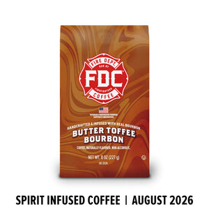 A bag of FDC Fire Department Bourbon Butter Toffee Bourbon coffee on a white background, with black text below reading 'SPIRIT INFUSED COFFEE | AUGUST 2026'. The bag is brown with red and cream swirls and a red FDC logo.