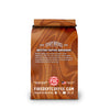 A bag of Fire of the Coast Coffee Company Butter Toffee Bourbon coffee, featuring a brown and tan marbled design on a white background.
