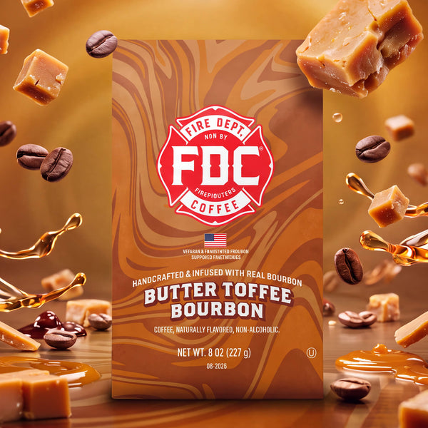 A bag of FDC Fire Department Bourbon Butter Toffee Bourbon coffee on a white background, with black text below reading 'SPIRIT INFUSED COFFEE | AUGUST 2026'. The bag is brown with red and cream swirls and a red FDC logo.