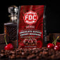 FDC Coffee package with chocolate-dipped cherry bourbon flavor, surrounded by coffee beans and cherries.