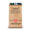 A standing coffee bag package on a plain white background. The bag is tan with wood-grain printed graphics and text, including 'COSTA RICA' and 'FIREDEPTCOFFEE.