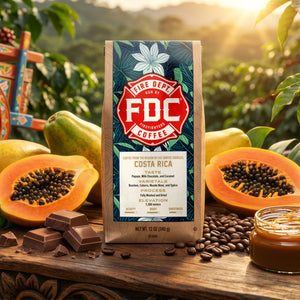 A bag of FDC Fire Department Coffee from Costa Rica, shown next to flavor illustrations for papaya, milk chocolate, and caramel, with text reading 'Tasting Notes' and 'Coffee from Costa Rica | July 2026'.