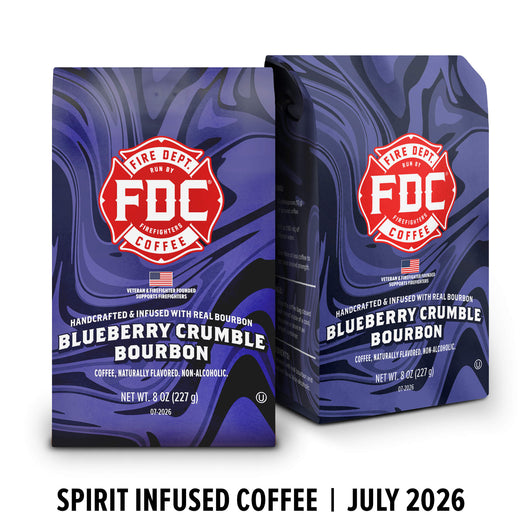 Two bags of FDC Fire Department Coffee Blueberry Crumble Bourbon coffee on a white background with a black text banner at the bottom reading ’SPIRIT INFUSED COFFEE | JULY 2026’.