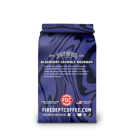 A bag of Firedeep Coffee Company Blueberry Crumble Bourbon coffee on a plain white background. The packaging is dark blue with a glossy, marbled pattern and features the brand name ’Spirit Infused Coffee’ and product name ’Blueberry Crumble Bourbon’.