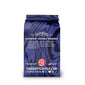 A bag of Firedeep Coffee Company Blueberry Crumble Bourbon coffee on a plain white background. The packaging is dark blue with a glossy, marbled pattern and features the brand name ’Spirit Infused Coffee’ and product name ’Blueberry Crumble Bourbon’.