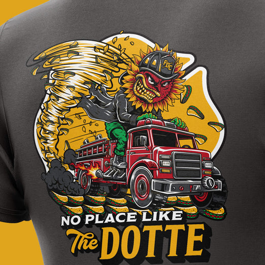 T-shirt with a graphic of a red truck, angry eagle, and text ’No Place Like The Dotte’ on a yellow background.