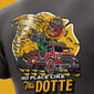 T-shirt with a graphic of a red truck, angry eagle, and text ’No Place Like The Dotte’ on a yellow background.