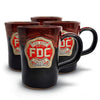 A group of four Fire Department Coffee Hand Dipped 10 Year Anniversary Pottery Mugs with a white background. 