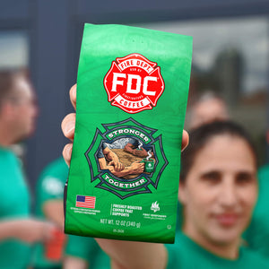 Green bag of Fire Department Coffee with logo and text on a white background