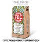 A bag of FDC Coffee from Tanzania stands upright on a white background. The package has a natural wood-toned side and a colorful geometric label in green, blue, and red.