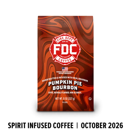 A bag of FDC Fire Department Bourbon Coffee, Pumpkin Pie Bourbon flavor, featuring a red and orange marbled design with a white FDC logo. The bag is shown against a white background with a black text banner at the bottom reading ’SPIRIT INFUSED COFFEE | OCTOBER 2026’.