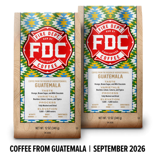 Two FDC Coffee packages shown side by side on a white background, with a black text banner at the bottom reading ’COFFEE FROM GUATEMALA | SEPTEMBER 2026’. The packages feature a colorful geometric pattern and a large red FDC logo.